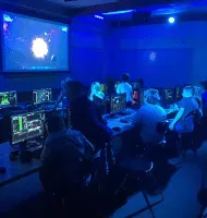 A school computer lab running a Mission, every screen part of one ship.