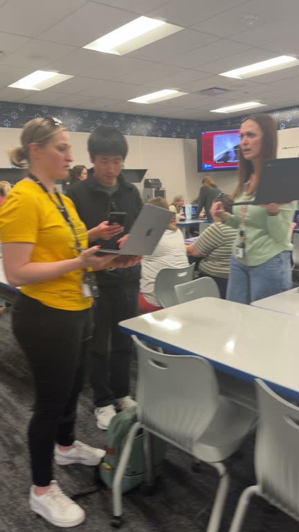 Teachers on their feet with laptops in hand, mid-Mission.